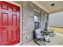 Cozy front porch featuring a red door and comfortable seating, perfect for relaxing outdoors at 5452 Fountainhead Ln, Auburn, GA 30011