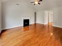Bright living room with hardwood floors, fireplace, vaulted ceiling, and neutral paint at 6405 Beaver Creek Trl, Atlanta, GA 30349