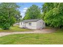 A charming single-story home features newly painted siding, a well maintained lawn and mature trees at 1350 Redford Se Dr, Atlanta, GA 30315