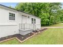 A freshly painted home features a beautifully landscaped front yard, brick accents and welcoming entrance at 1350 Redford Se Dr, Atlanta, GA 30315