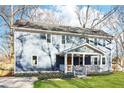 Inviting two-story home with a landscaped yard, enhanced by flowering plants along the driveway at 1977 Nash Se Ave, Atlanta, GA 30316