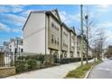 Brick townhome exterior featuring neutral trim, fenced yard, and sidewalk access at 635 Broadview Ne Pl, Atlanta, GA 30324