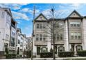 Charming townhome with brick facade, fenced yard, and multiple windows at 635 Broadview Ne Pl, Atlanta, GA 30324