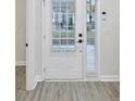Bright entryway with white door and trim, light gray walls and vinyl flooring at 2587 Ocean Walk Nw Dr, Atlanta, GA 30318