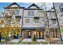 Charming townhouse with light colored siding, black trim, and tasteful landscaping at 2587 Ocean Walk Nw Dr, Atlanta, GA 30318