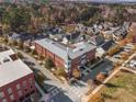 Aerial view of a red brick multi-unit building with mature trees, surrounding neighborhoods and fall foliage at 4143 N Swann St, Covington, GA 30014