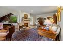 Cozy living room with a fireplace, piano, stylish furniture, and elegant decor at 44 Muscogee Nw Ave, Atlanta, GA 30305