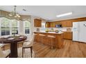 Bright kitchen with wooden cabinets, a breakfast bar, and hardwood floors at 1561 Oak Ivy Ln, Lawrenceville, GA 30043