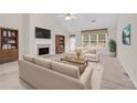 Cozy living room with fireplace, neutral furniture, and plenty of natural light at 1561 Oak Ivy Ln, Lawrenceville, GA 30043