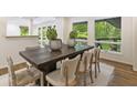 Bright dining room with large windows and a modern table set for six at 1860 Mountain Shadow, Stone Mountain, GA 30087