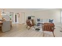Open-concept living and dining area with hardwood floors and neutral decor; great for entertaining at 2117 Bucktrout Pl, Dunwoody, GA 30338
