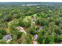An aerial view shows a neighborhood surrounded by mature trees and a golf course at 4079 Essex Dr, Villa Rica, GA 30180
