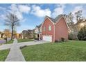 Lovely two-story home with brick and siding and a well-manicured lawn at 1558 Park Knoll Trl, Lawrenceville, GA 30043