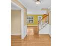 Foyer featuring hardwood floors and a staircase with white trim at 1558 Park Knoll Trl, Lawrenceville, GA 30043