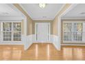 Bright foyer with hardwood floors and white trim details at 1558 Park Knoll Trl, Lawrenceville, GA 30043