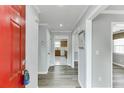 Hallway with gray walls and wood look floors, offers a glimpse into the well-lit kitchen at 5555 Sugar Crossing Dr, Sugar Hill, GA 30518