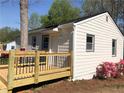Cozy home featuring a new wooden deck, updated siding, and cheerful landscaping at 725 S Fork Sw Dr, Marietta, GA 30008