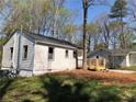 Well-maintained home exterior with a deck, tidy yard, and fresh neutral siding at 725 S Fork Sw Dr, Marietta, GA 30008