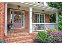 Inviting front porch with brick steps, white railing, and tasteful landscaping at 116 Patrick Way, Marietta, GA 30064