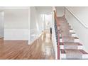 Inviting foyer with hardwood floors, staircase, and classic white wainscoting at 12348 Hillcrest Dr, Hampton, GA 30228