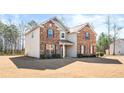 Two story house with brick and siding with a well manicured lawn at 12348 Hillcrest Dr, Hampton, GA 30228