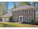 Beautiful two-story home with a well-maintained lawn and front yard landscaping at 1627 Isham Dr, Lawrenceville, GA 30046