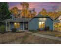 Charming single-story home with blue siding, a covered front porch, and a landscaped front yard at 3918 S Creek Ct, Stone Mountain, GA 30083