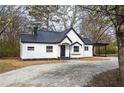Charming renovated home featuring white siding, black roof, and inviting front entrance at 65 Sage St, Temple, GA 30179