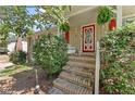 Inviting front porch featuring a red door and decorative plants at 2062 Cezar Nw Dr, Kennesaw, GA 30152
