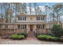 Charming two-story home boasts a welcoming front porch and landscaped yard, perfect for outdoor enjoyment at 4211 Burnt Hickory Nw Rd, Marietta, GA 30064