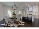 Eat-in kitchen boasts white cabinets, stainless appliances, and a stylish dining area at 3481 Landen Pine Ne Ct, Atlanta, GA 30305