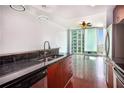 Modern kitchen boasts stainless steel appliances, granite countertops, and hardwood floors at 361 17Th Nw St # 2407, Atlanta, GA 30363