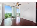 Bright living room features hardwood floors and floor-to-ceiling windows with a city view at 361 17Th Nw St # 2407, Atlanta, GA 30363