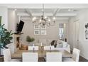 Open-concept dining and living area includes fireplace, coffered ceilings and views to adjoining areas at 3332 Old Concord Se Rd, Smyrna, GA 30082