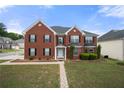 Charming brick home with a well-maintained front yard and a stone pathway to the entrance at 4699 Price St, Forest Park, GA 30297