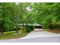 Well-maintained home nestled among mature trees with a long driveway at 87 Valley Rd, Lawrenceville, GA 30044
