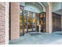 Close-up of the building's entrance, featuring a glass door, stone accents, and a modern design at 275 13Th Ne St # 409, Atlanta, GA 30309