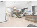 A spacious lobby with modern lighting, tile flooring, a grand staircase, and a reception desk at 275 13Th Ne St # 409, Atlanta, GA 30309