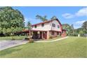 Traditional two-story home featuring a carport, brick accents, and a well-maintained lawn at 3510 Spring Valley Blvd, Atlanta, GA 30349