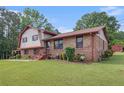 Inviting brick home with a manicured lawn and landscaping, offering classic curb appeal at 3510 Spring Valley Blvd, Atlanta, GA 30349
