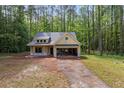 Charming single-story home featuring an attached two car garage and classic architectural details at 48 Paschal St, Temple, GA 30179