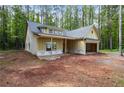Charming single-story home featuring an attached two car garage and classic architectural details at 48 Paschal St, Temple, GA 30179