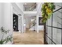 Entryway featuring hardwood floors, view of stairs and a modern light fixture at 1206 Kincaid Rd, Marietta, GA 30066