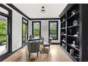 Bright office featuring hardwood floors, built-in shelving, and backyard views at 1206 Kincaid Rd, Marietta, GA 30066