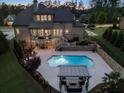 Aerial showcasing a backyard oasis, complete with a sparkling pool, outdoor seating, and lush landscaping at 3024 Malbec Vly, Acworth, GA 30101