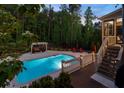 Beautiful pool area featuring a pool, deck, lounge chairs, and lush landscaping at 3024 Malbec Vly, Acworth, GA 30101