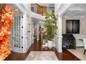 Elegant foyer with soaring ceilings, hardwood floors, staircase, and sophisticated decor at 580 Grimsby Ct, Suwanee, GA 30024