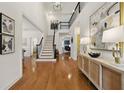 Grand foyer featuring hardwood floors, a staircase with black railings, and stylish decor at 6355 Glen Oaks Ln, Atlanta, GA 30328