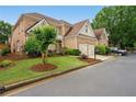Beautifully landscaped brick home with a two-car garage and well-maintained lawn in a suburban setting at 6355 Glen Oaks Ln, Atlanta, GA 30328