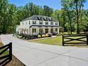 Stunning home features a long driveway, lush landscaping, and a welcoming front porch perfect for relaxing and enjoying at 650 Jones Rd, Roswell, GA 30075